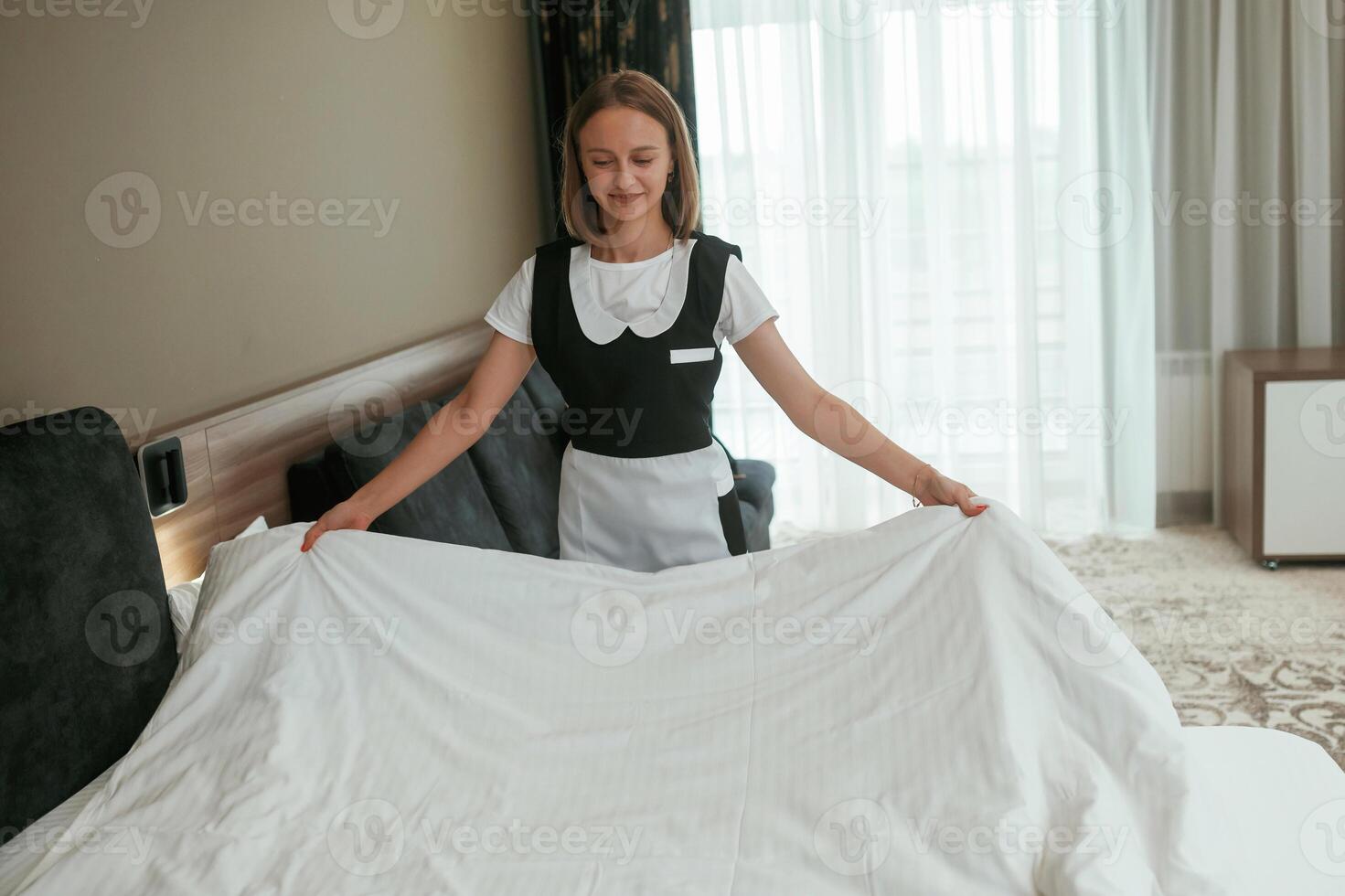 Busy, conception, of ,,work and occupation. Young chambermaid is in hotel room photo