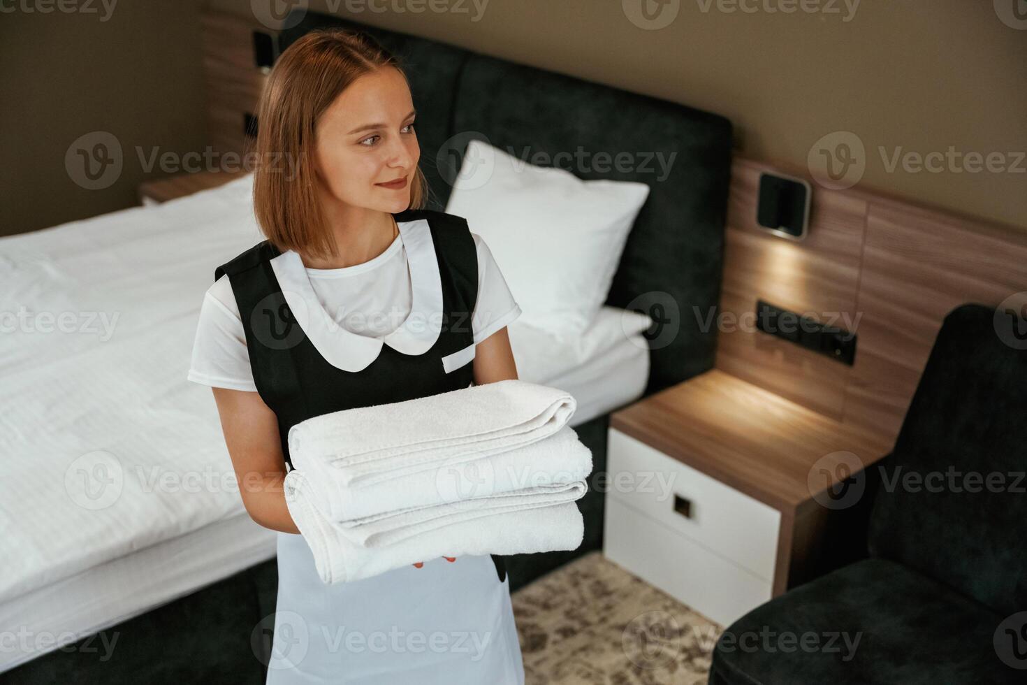 Beautiful woman... Young ,chambermaid is in hotel room photo