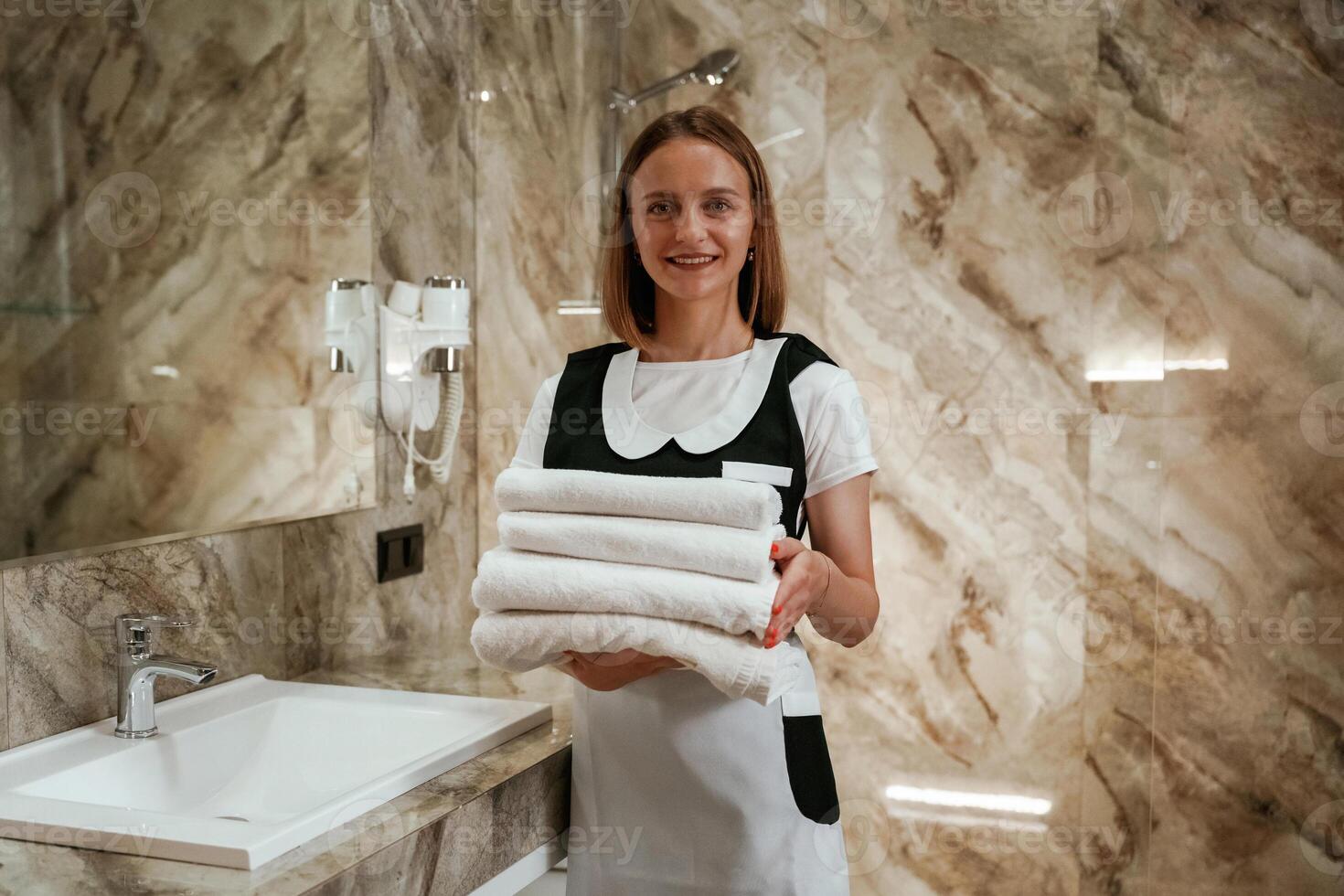 Bathroom interior. Young ,chambermaid is in hotel,, room photo