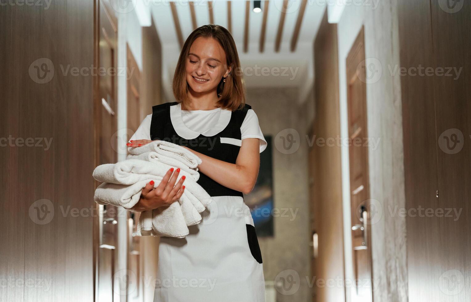 Front,, view, with fresh cloth. Chambermaid is standing in the hotel corridor photo