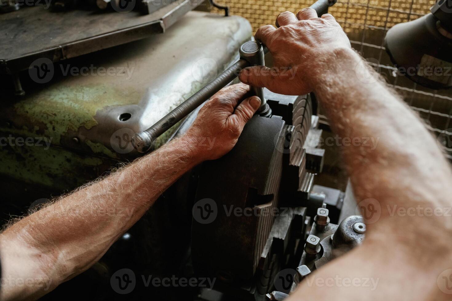Busy ,,man. Close-up of ,worker's hands operating industrial machinery in workshop photo