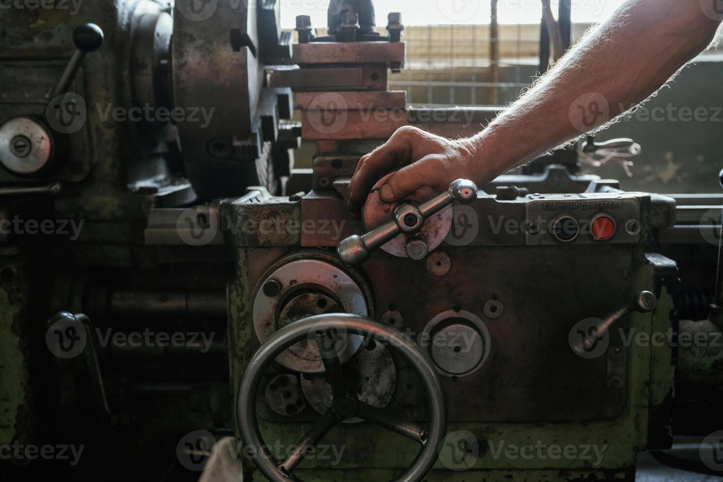 Busy, man. Close-up of worker's,, hands operating industrial machinery in workshop photo