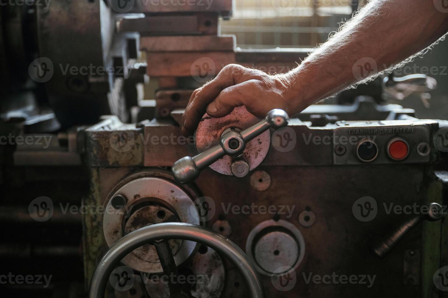 Busy man. Close-up of ,,worker's hands operating industrial machinery in workshop photo
