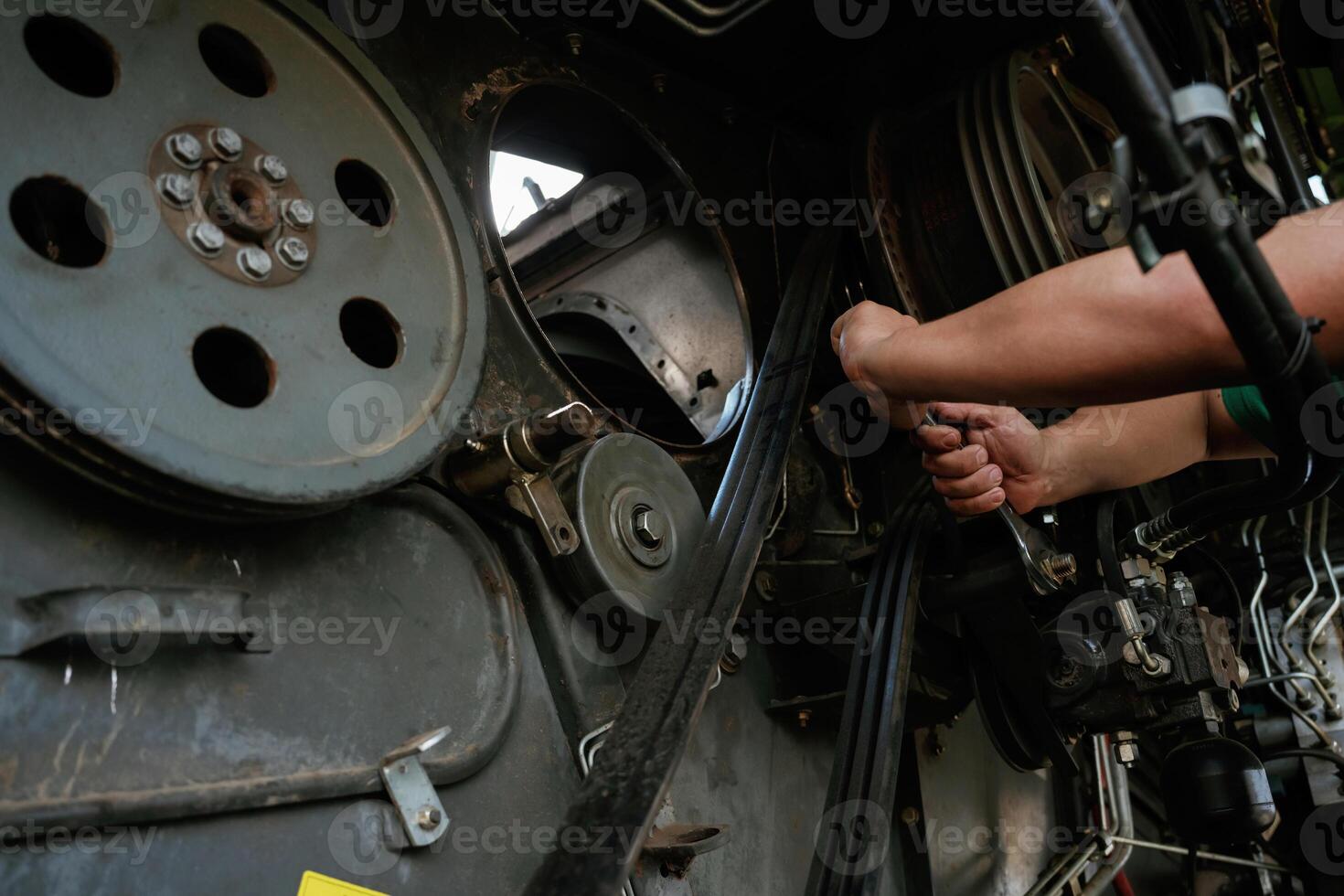 Mechanic, working on industrial machinery in a workshop photo