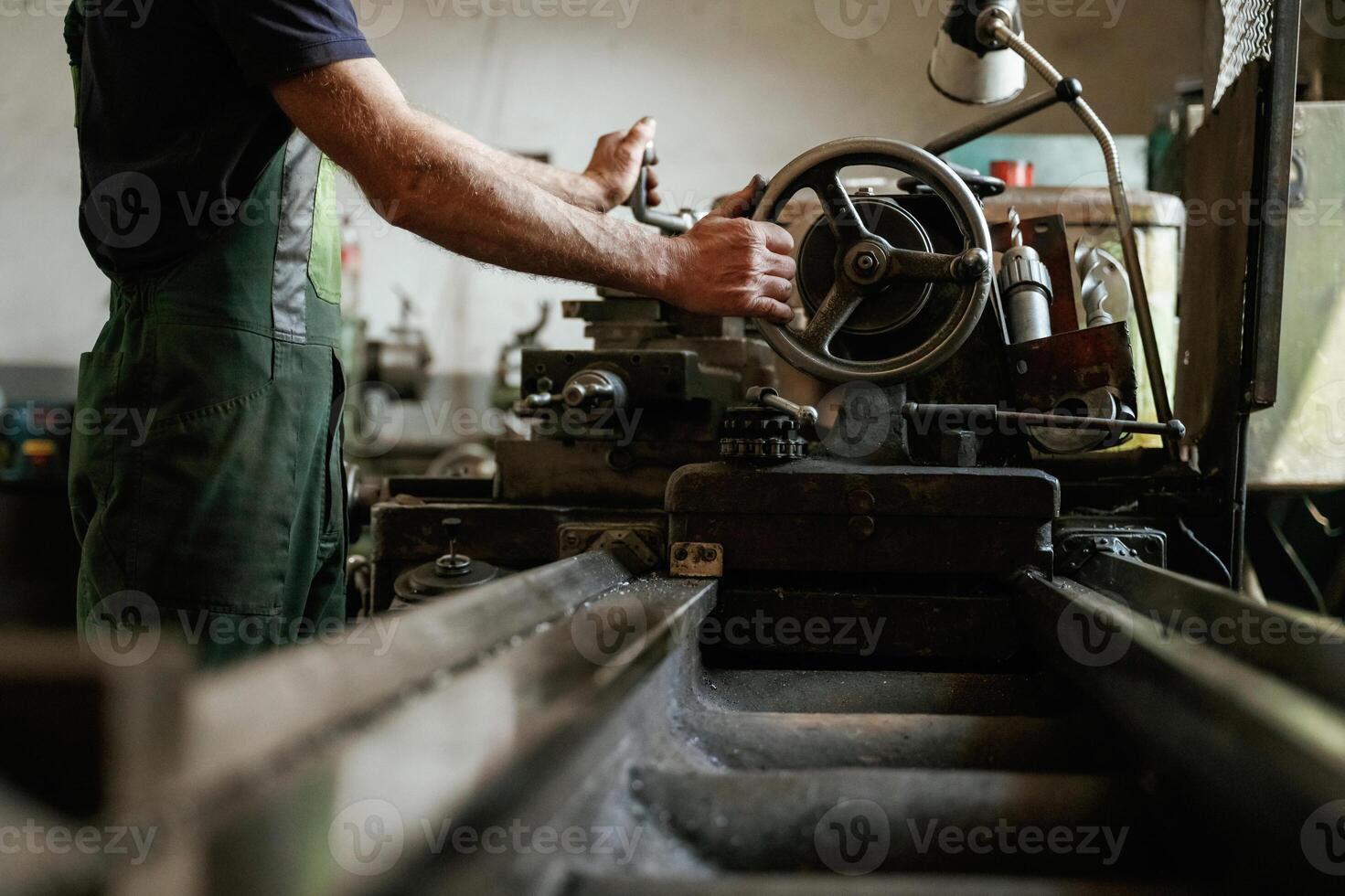 Side view. Close-up of worker's ,,hands operating industrial machinery in workshop photo