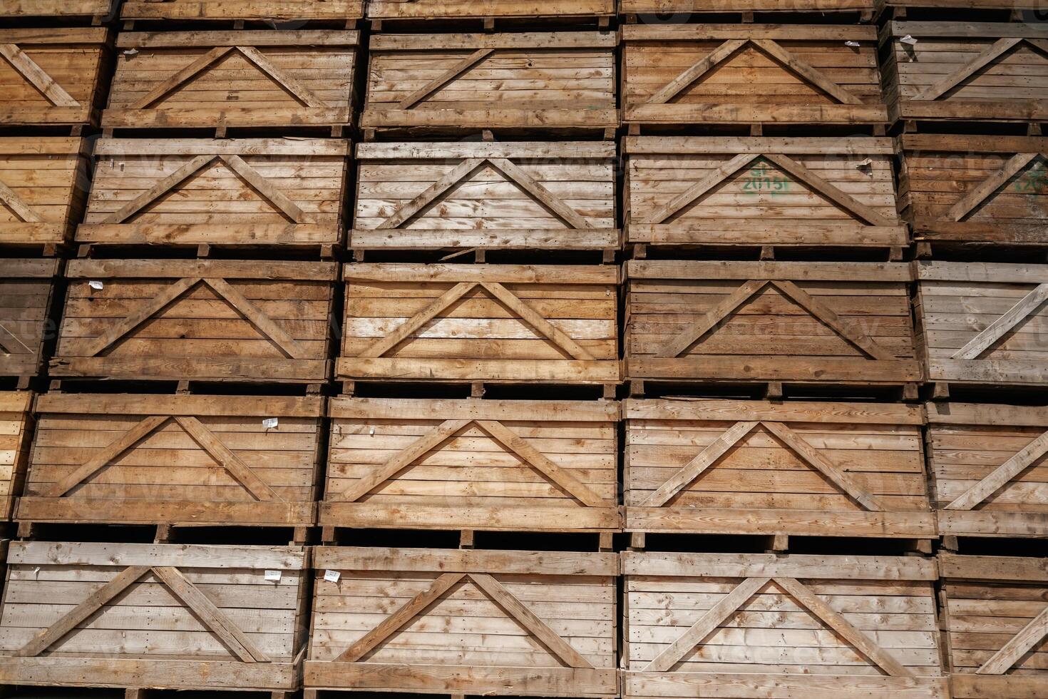 Stacked, wooden crates in an organized warehouse setting photo