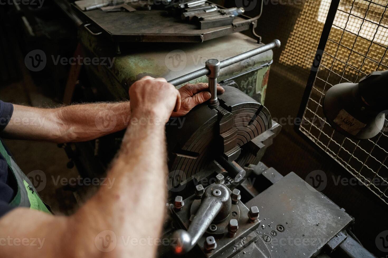 Focused view. Close-up, of worker's hands operating industrial machinery in workshop photo