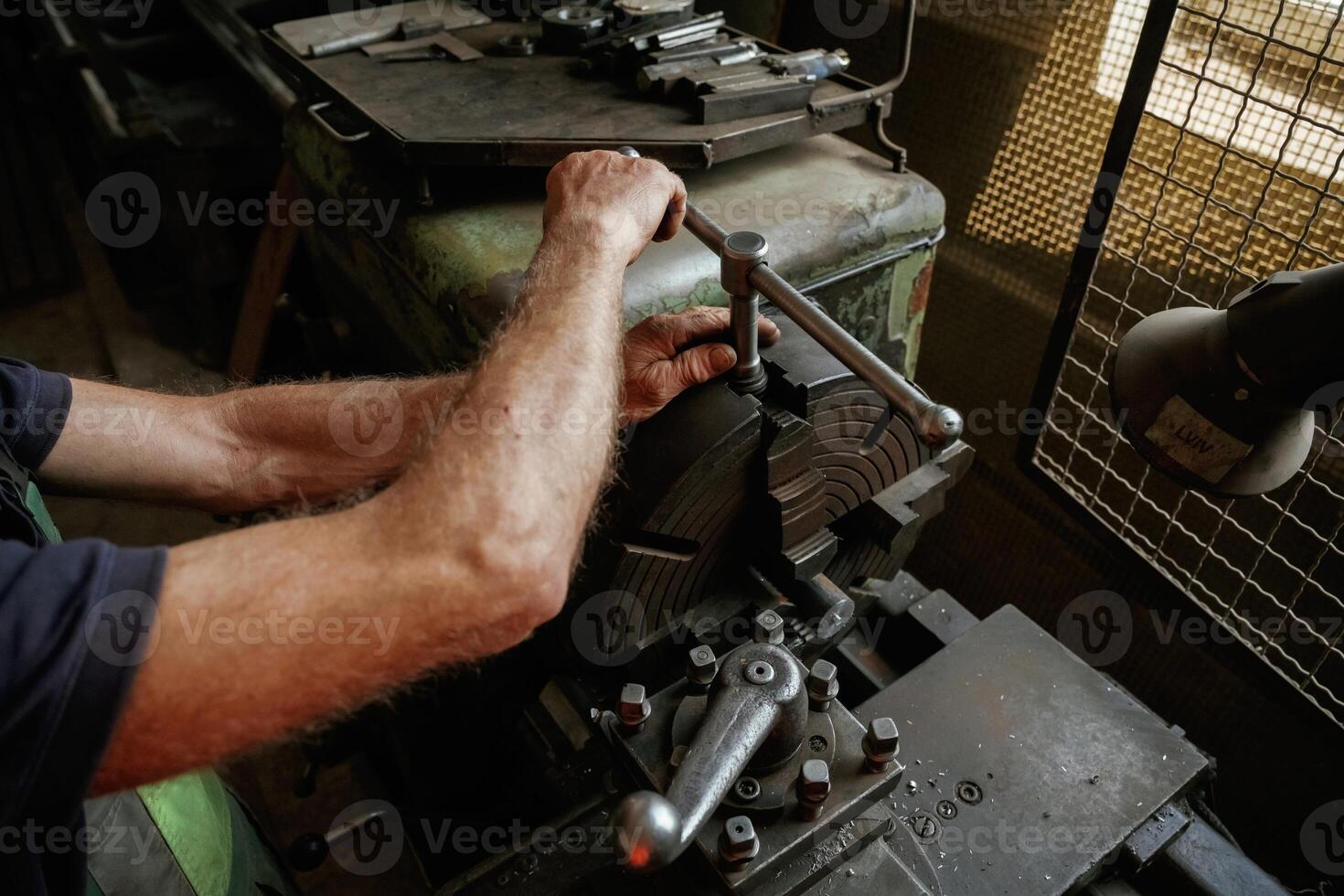 Focused ,view. Close-up of worker's hands operating industrial machinery in workshop photo