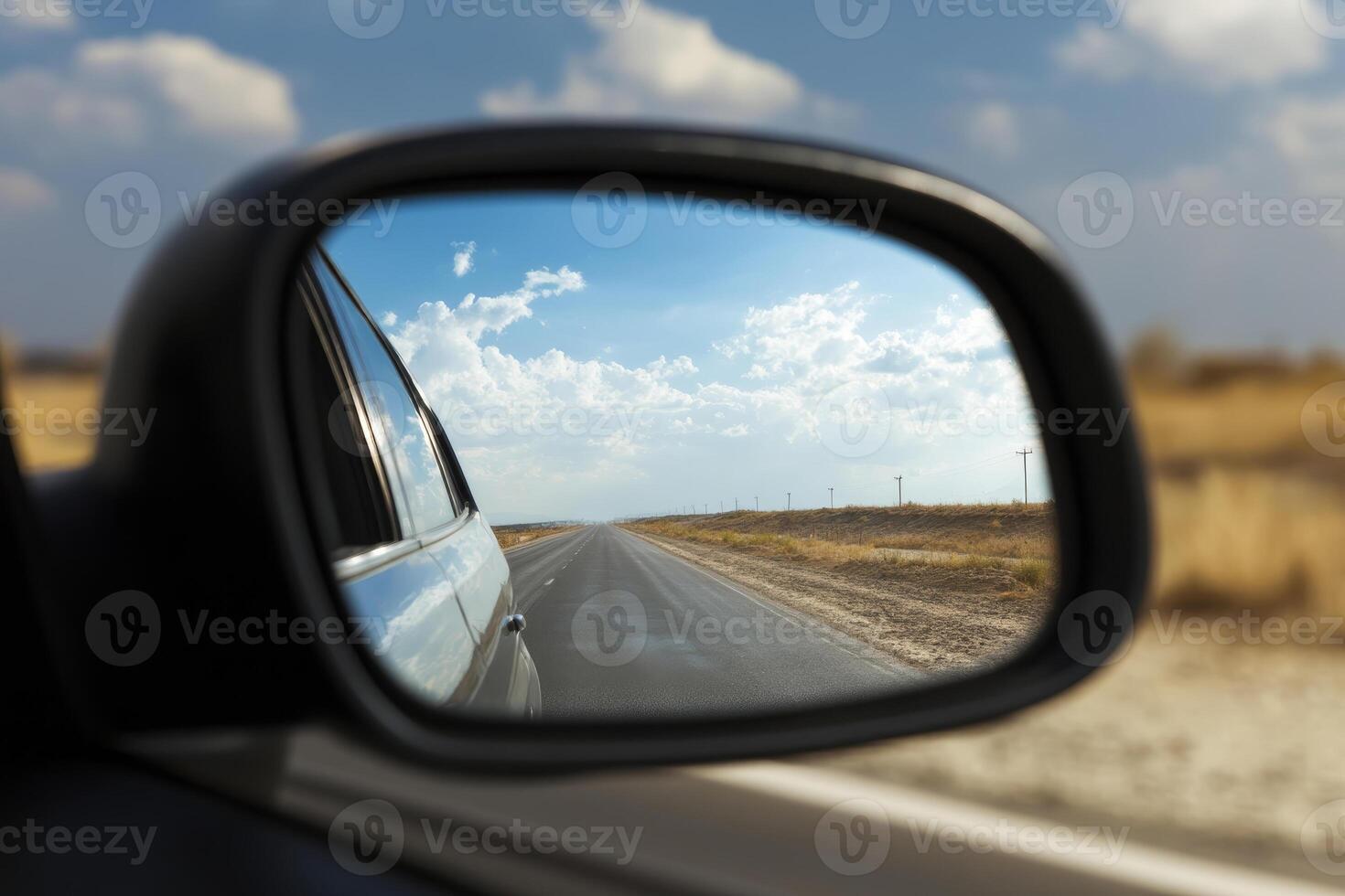 Close up of car rear view mirror with reflection of empty highway. Concept of of travel photo