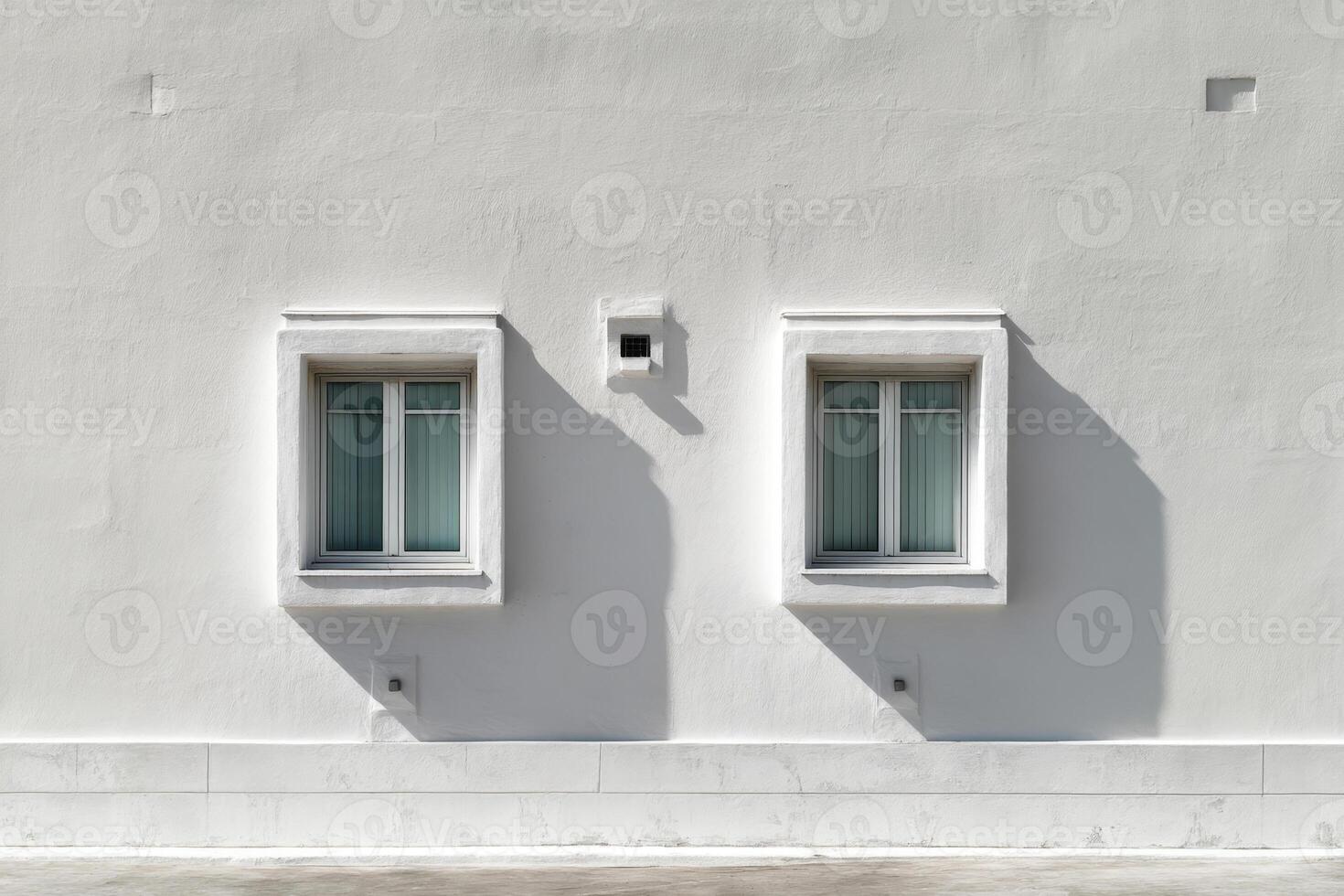 Building facade with two windows and shadows photo