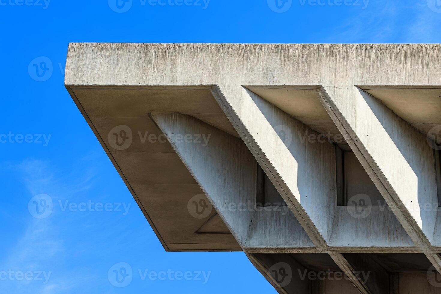 Close up of concrete building under clear sky. Brutalist architecture detail photo