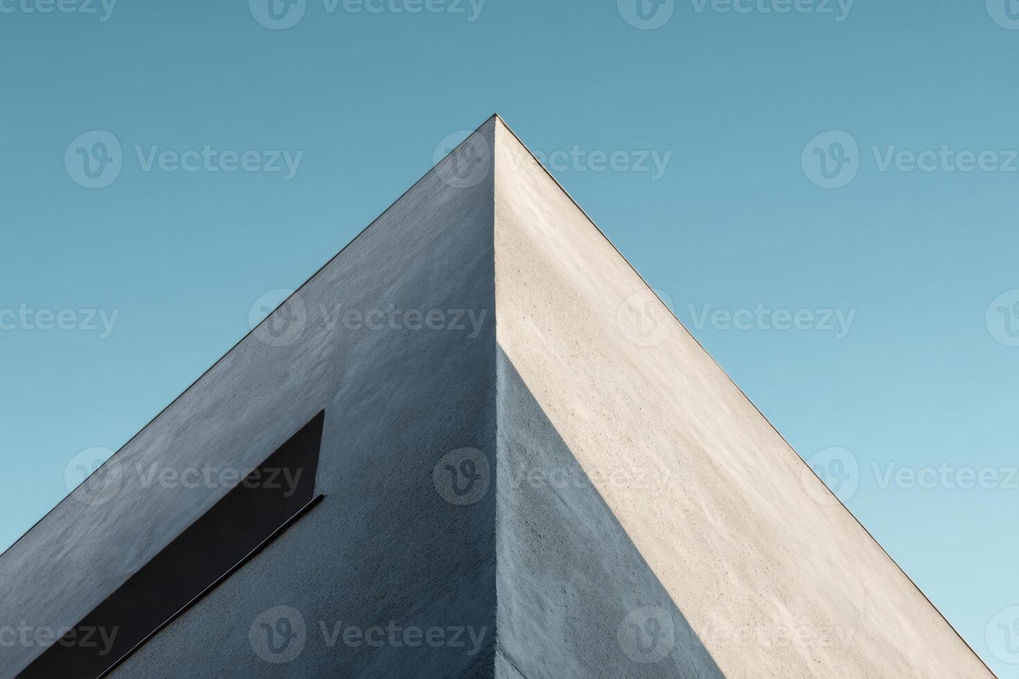 Detail of minimalist white building against clear blue sky photo