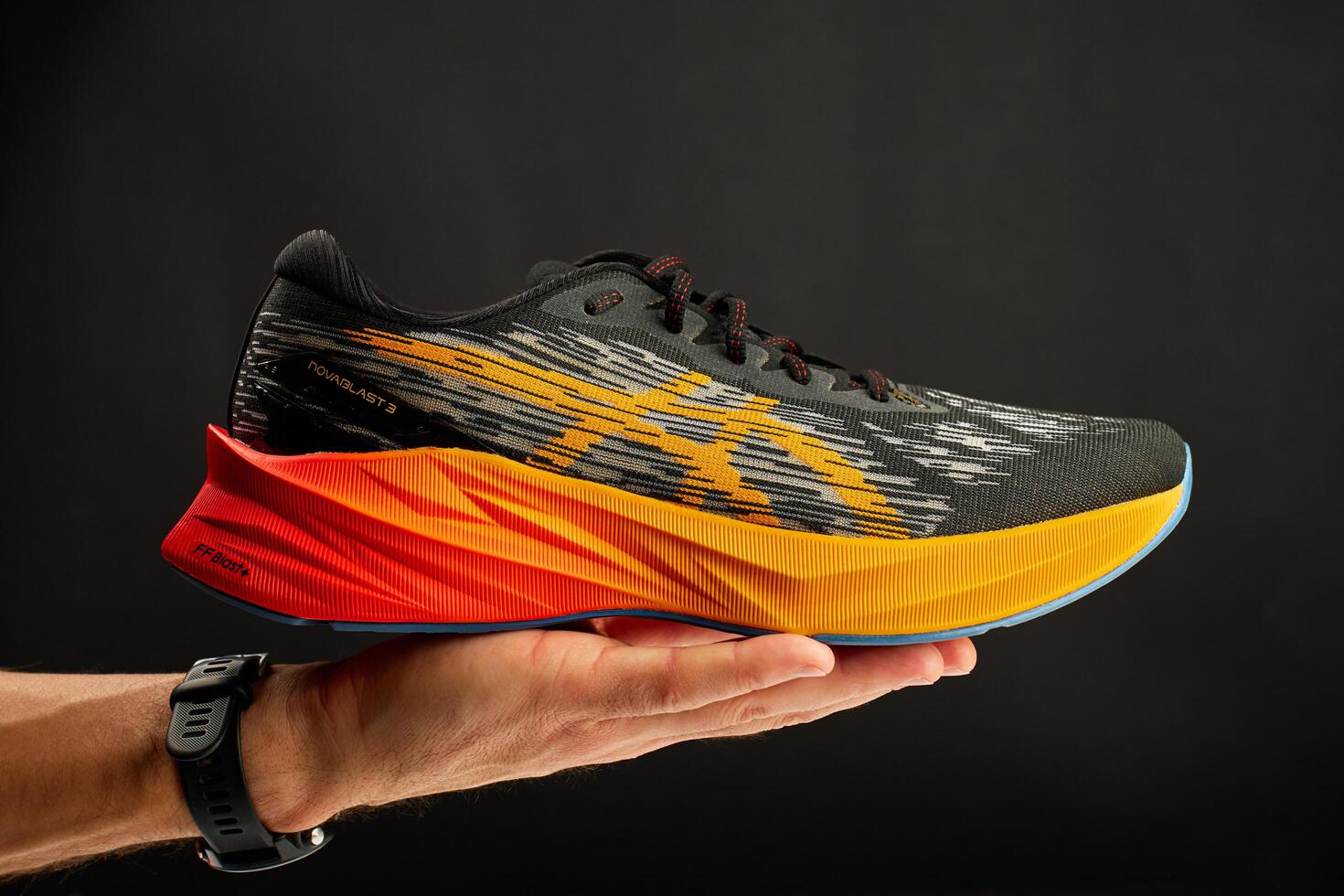 Wroclaw, Poland, 2024 - Running shoe with vibrant orange sole on dark background photo