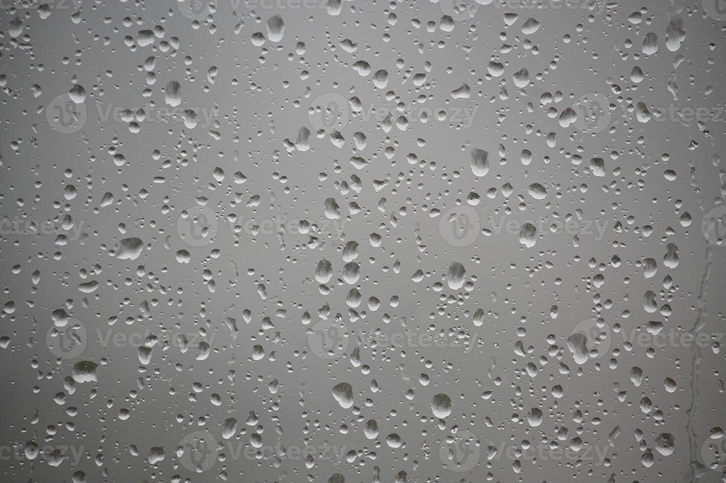 Raindrops Adorning a Windowpane on a Cloudy Day photo