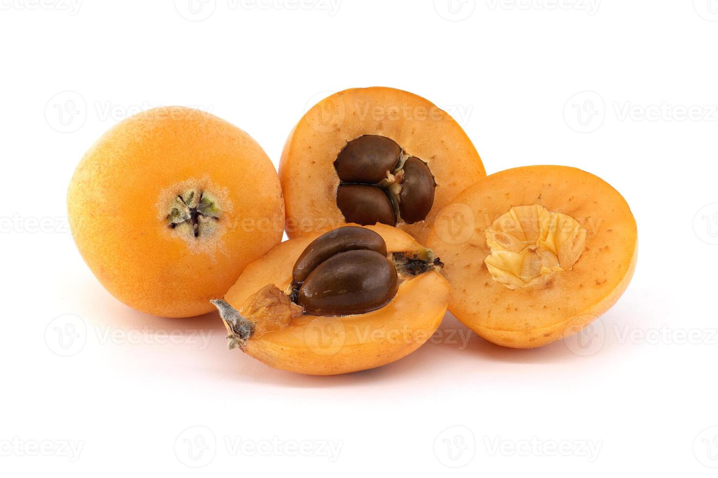 A close-up of fresh loquats, with some cut open to reveal their seeds and soft texture. photo