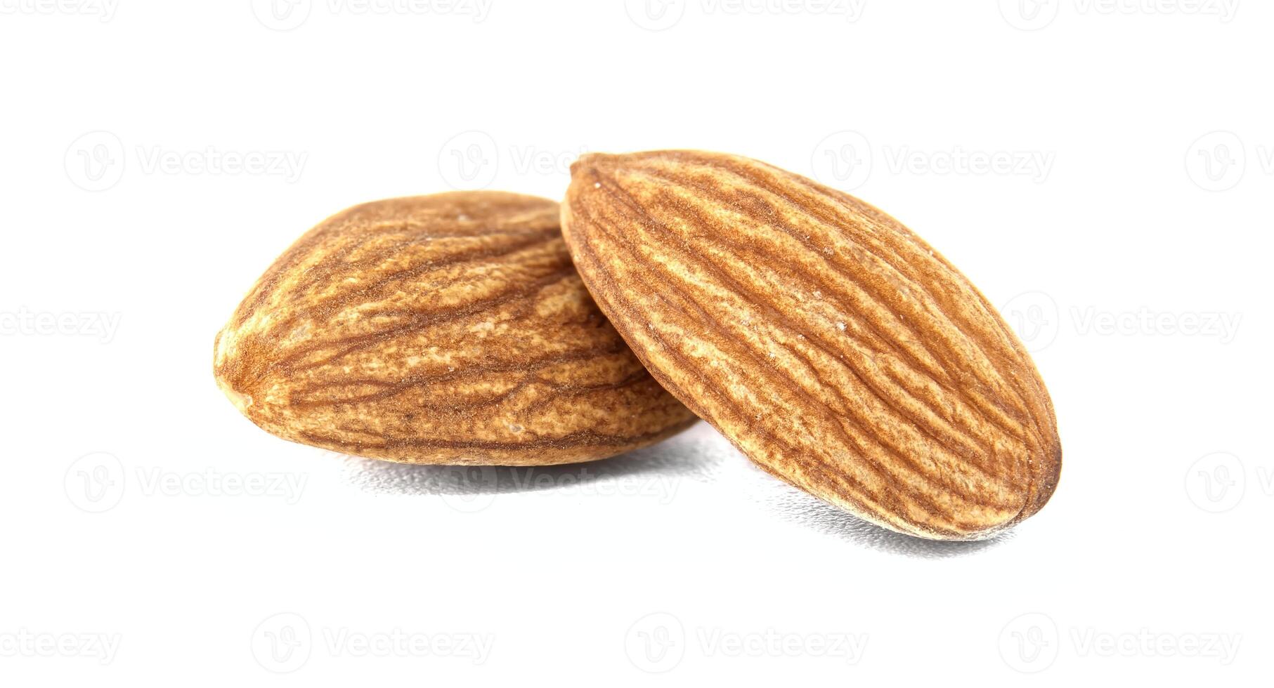 Two almonds, showcasing their textured surfaces and natural brown color, sit on a white background. photo
