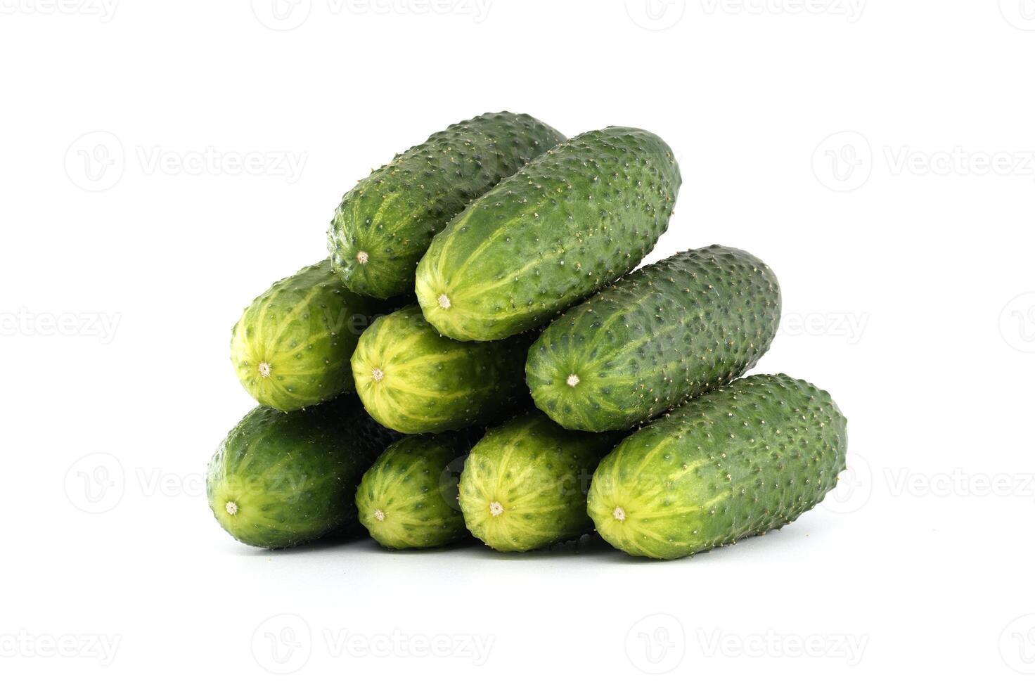 Neatly arranged pyramid of fresh, vibrant green cucumbers against a clean white backdrop. photo