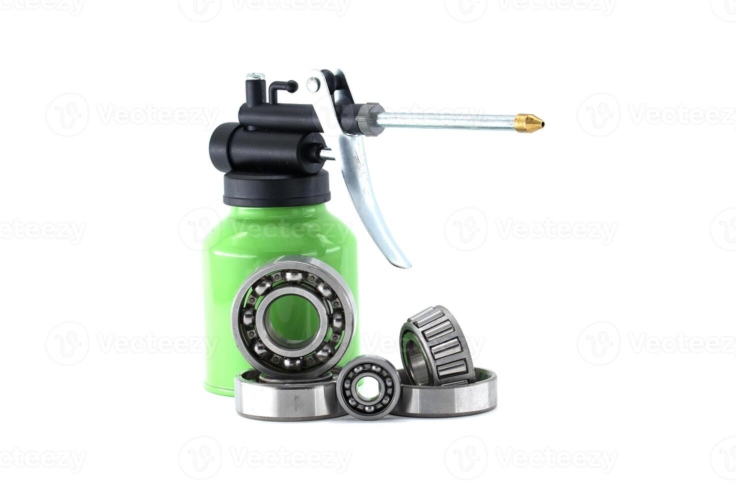 Green Oil Can with Metal Bearings on White Background for Industrial Use photo