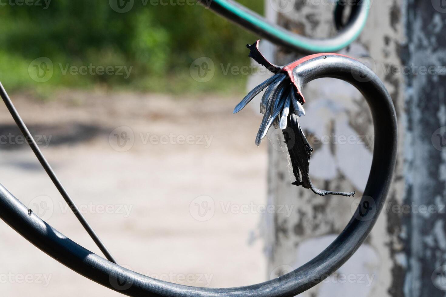 Broken black ground electric cord. Dangerous damage power electrical cable that can make electric leak and shock Unsafe work concept photo