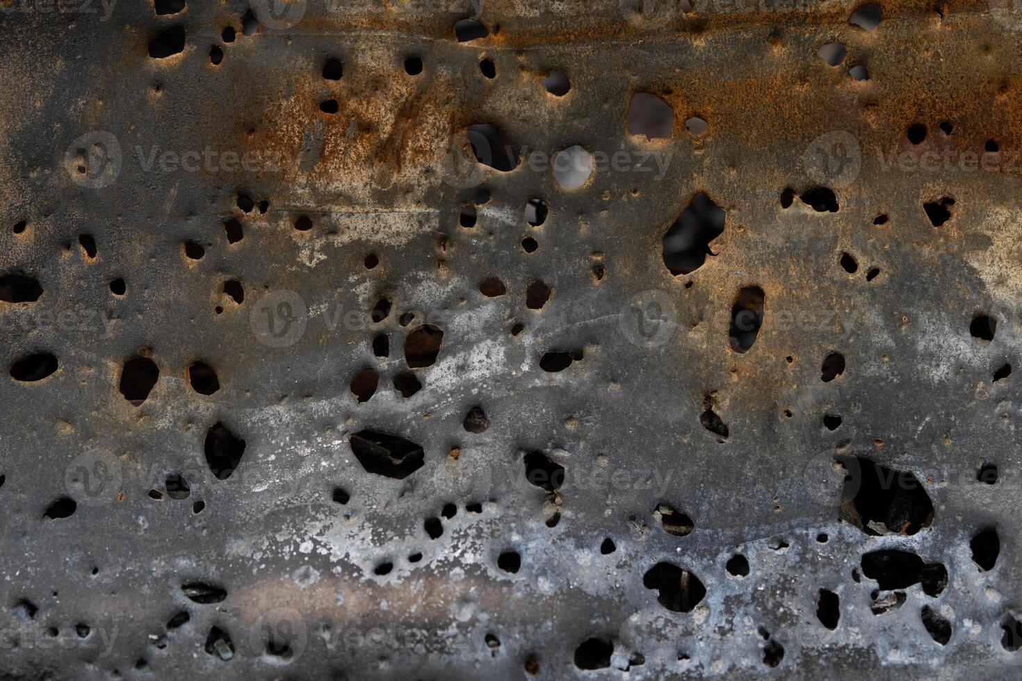 Texture of rusty iron with shrapnel damage for background. photo
