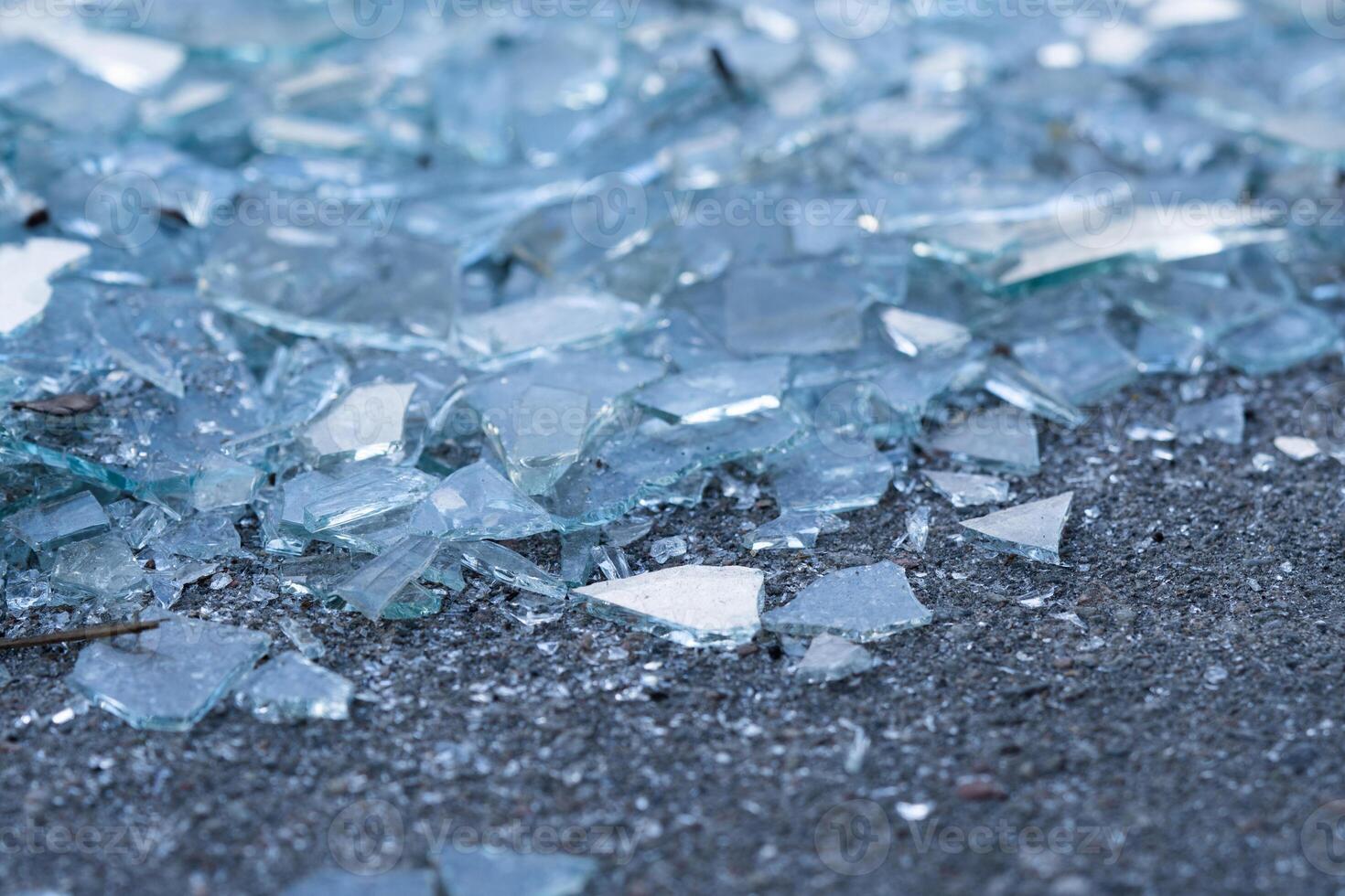 Shattered Glass. Background as broken pieces or crocks of white glass on the ground outdoors. Pine needles between glass pieces. photo