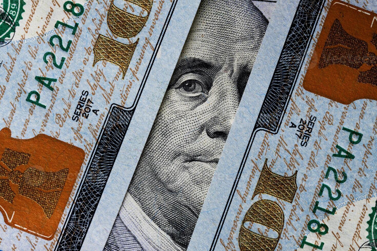 Benjamin Franklin's eyes from a hundred-dollar bill. The eyes of Benjamin Franklin on the hundred dollar banknote, backgrounds, close-up. 100 dollar bill with only eyes of Benjamin Franklin photo