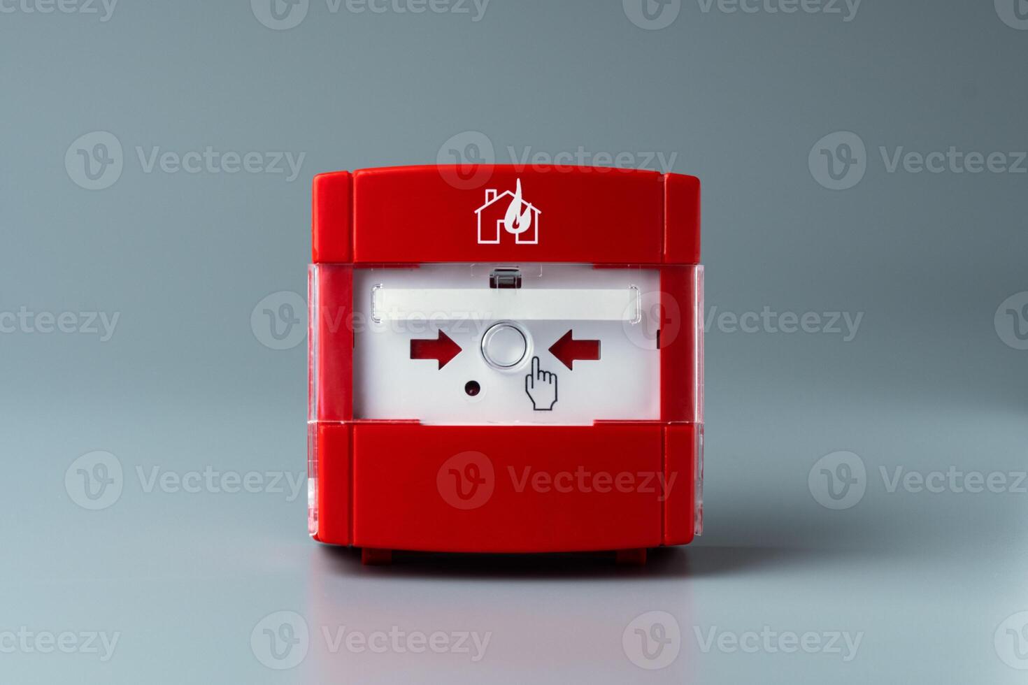 Red fire alarm on gray background. Close-up. photo