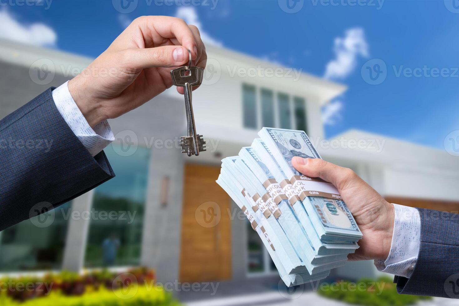 Man Handing a man Thousands of Dollars For Keys in Front of House. photo