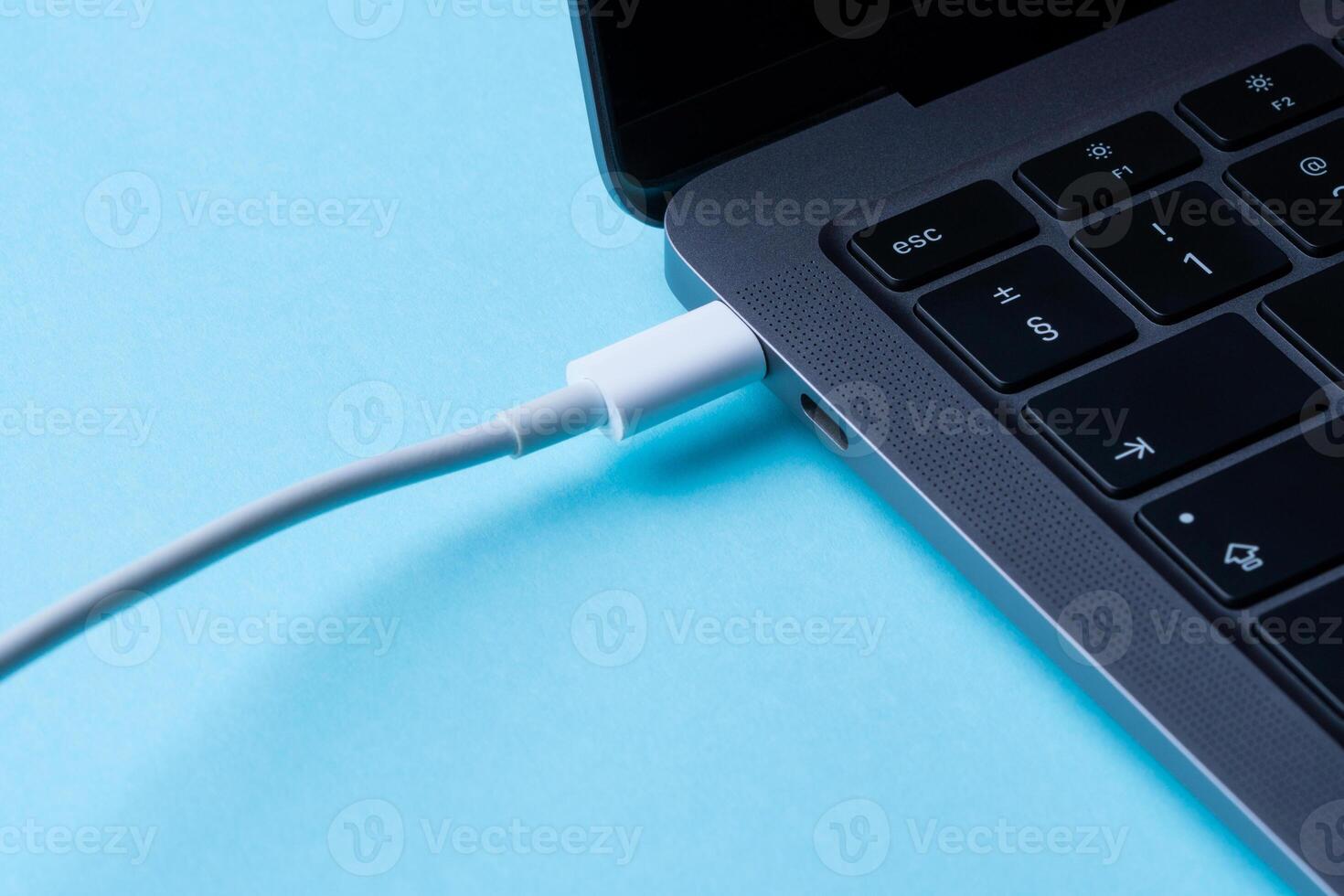 Laptop power. Cable with modern connector for charging and syncing your laptop with gadgets. Close-up. photo