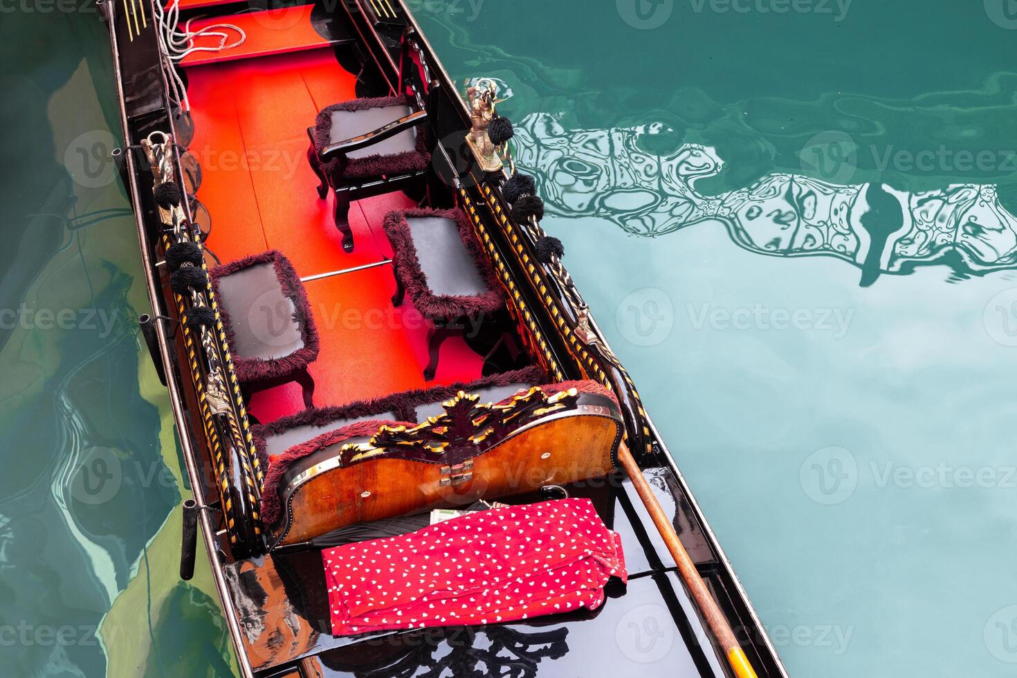 Romantic gondola interior with red seats photo