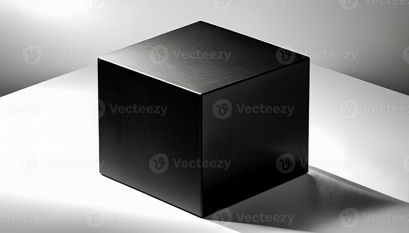 A black cube sitting on a white surface photo