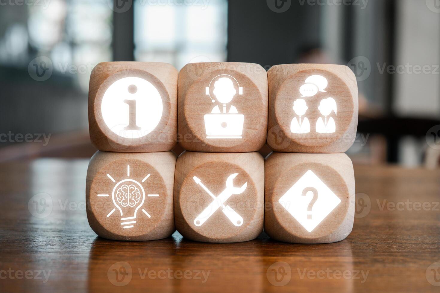 Wooden blocks with icons representing help desk concepts like information, support, teamwork, innovation, tools, and solutions. photo
