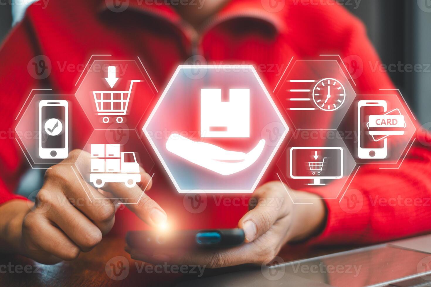 A person interacts with a smartphone, surrounded by digital icons representing online delivery services, showcasing modern e-commerce technology. photo