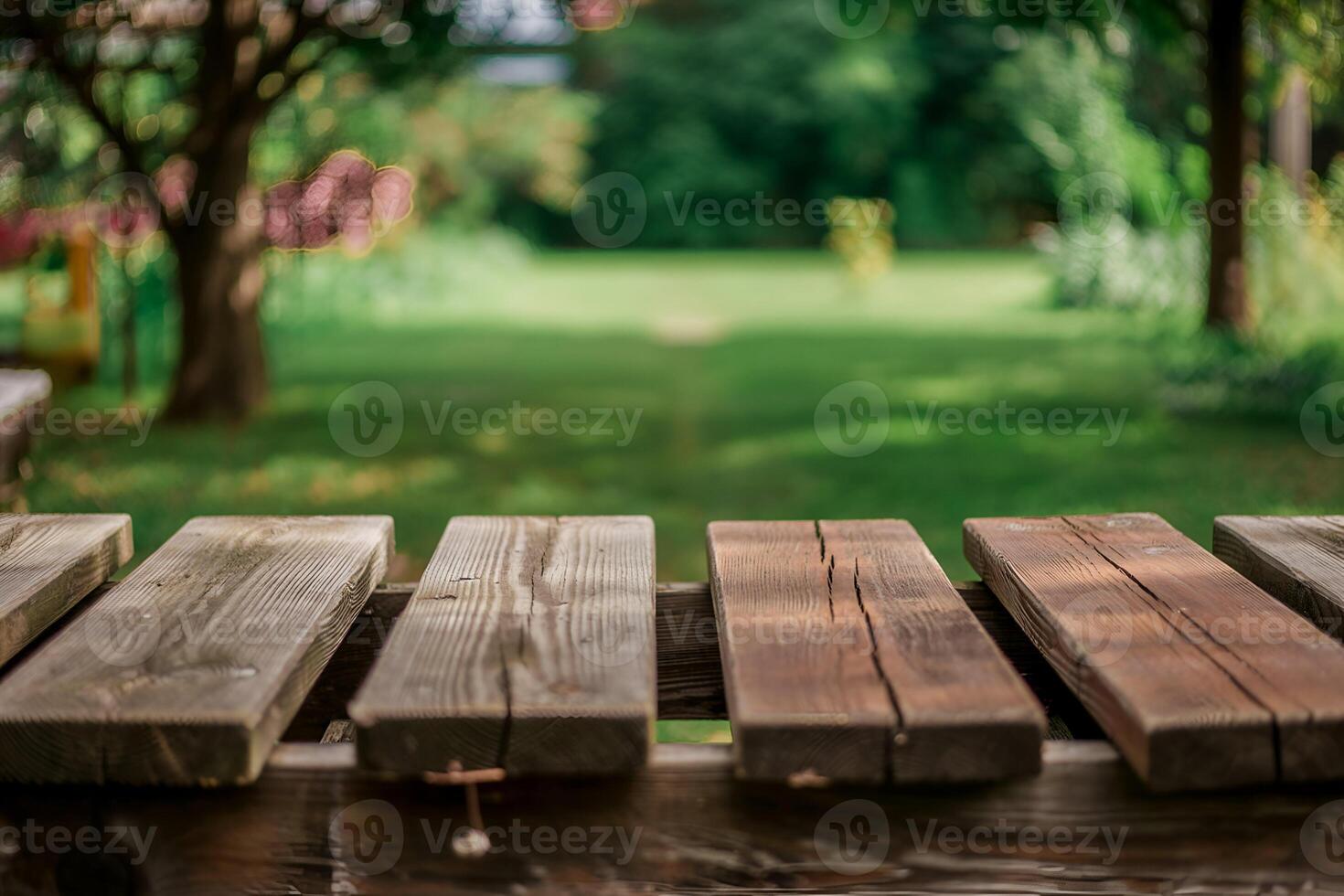 Weathered wooden planks with blurred green garden background photo