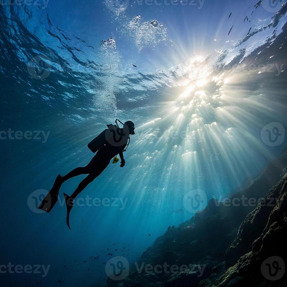a scuba diver in the ocean with sunlight shining through the water photo