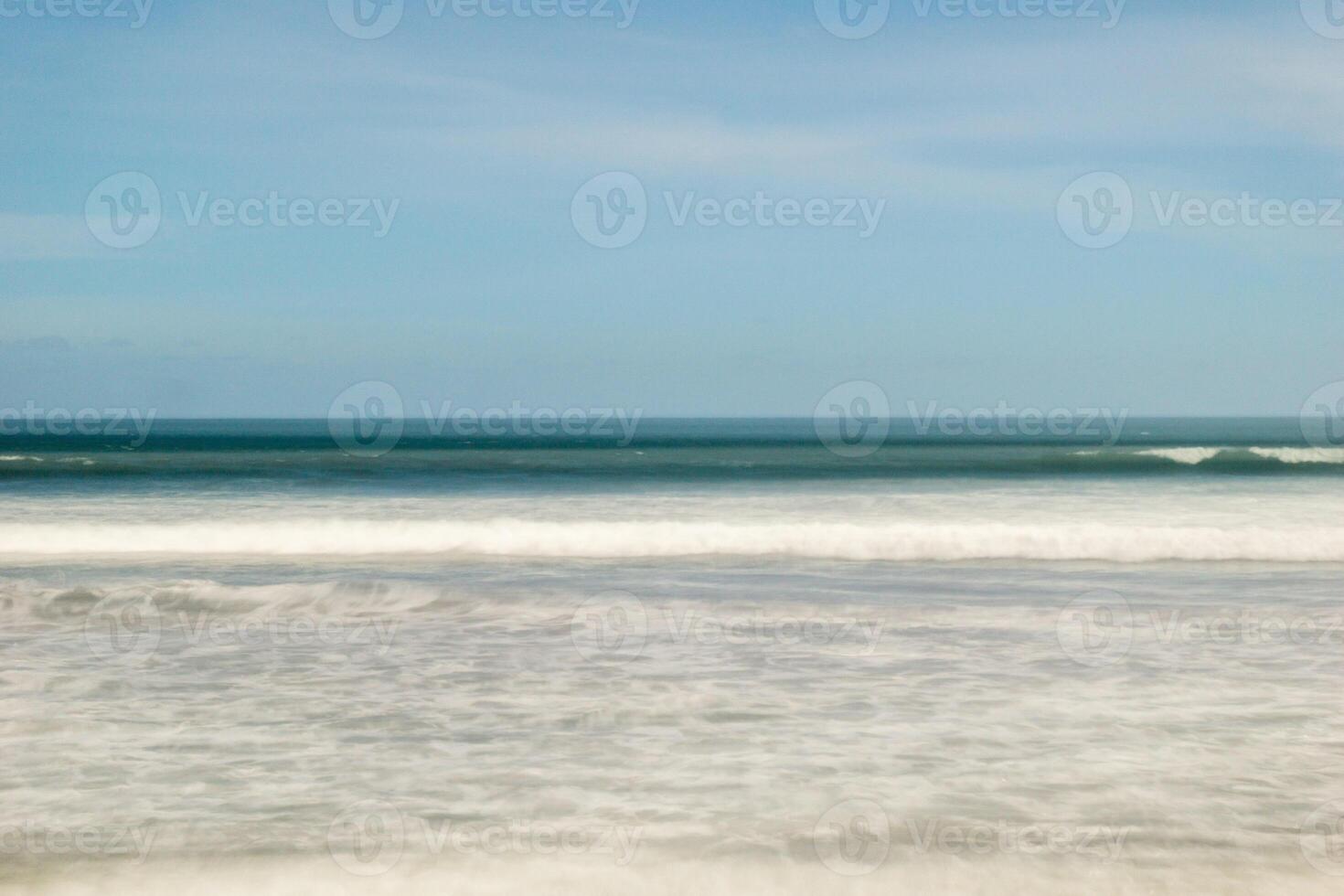 A surfer is riding a wave on the beach photo