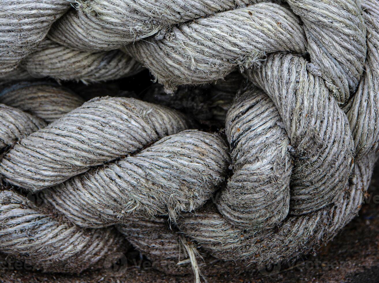 Closeup of thick braided marine rope. Coarse texture and rugged natural fibers used in shipping industry 01 photo