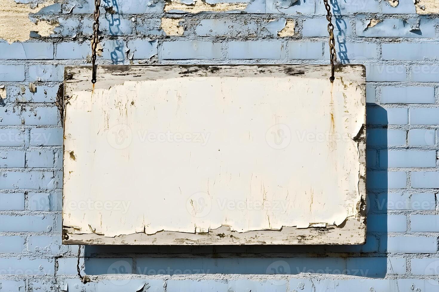 Weathered Blank Signboard Hanging on Blue Brick Wall with Peeling Paint, Ideal for Creative Projects Needing an Empty Space for Text or Graphics photo