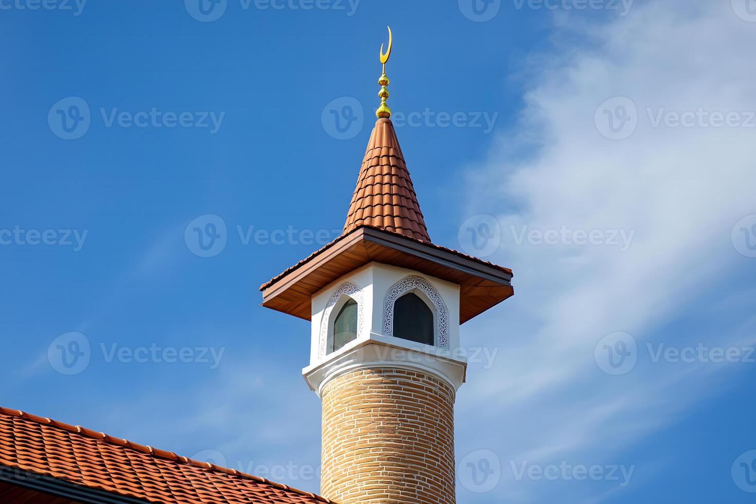 Beautiful Minaret with a Crescent Moon on Top Against a Clear Blue Sky Showcasing Traditional Islamic Architecture and Design Elements in Natural Light photo