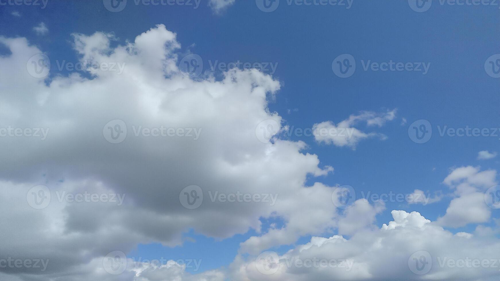 Bright White Clouds Floating in Blue Sky photo