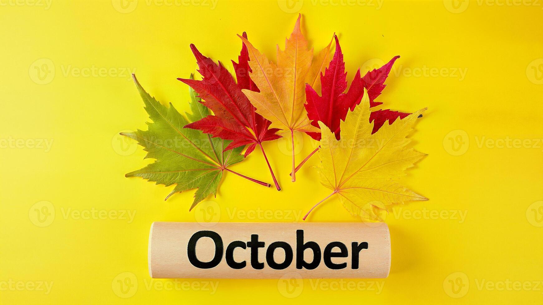 October Autumn Leaves on Yellow Background photo
