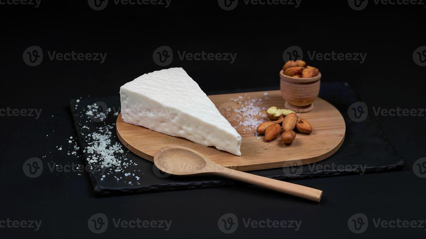 Slice of White Cheese with Almonds Displayed photo