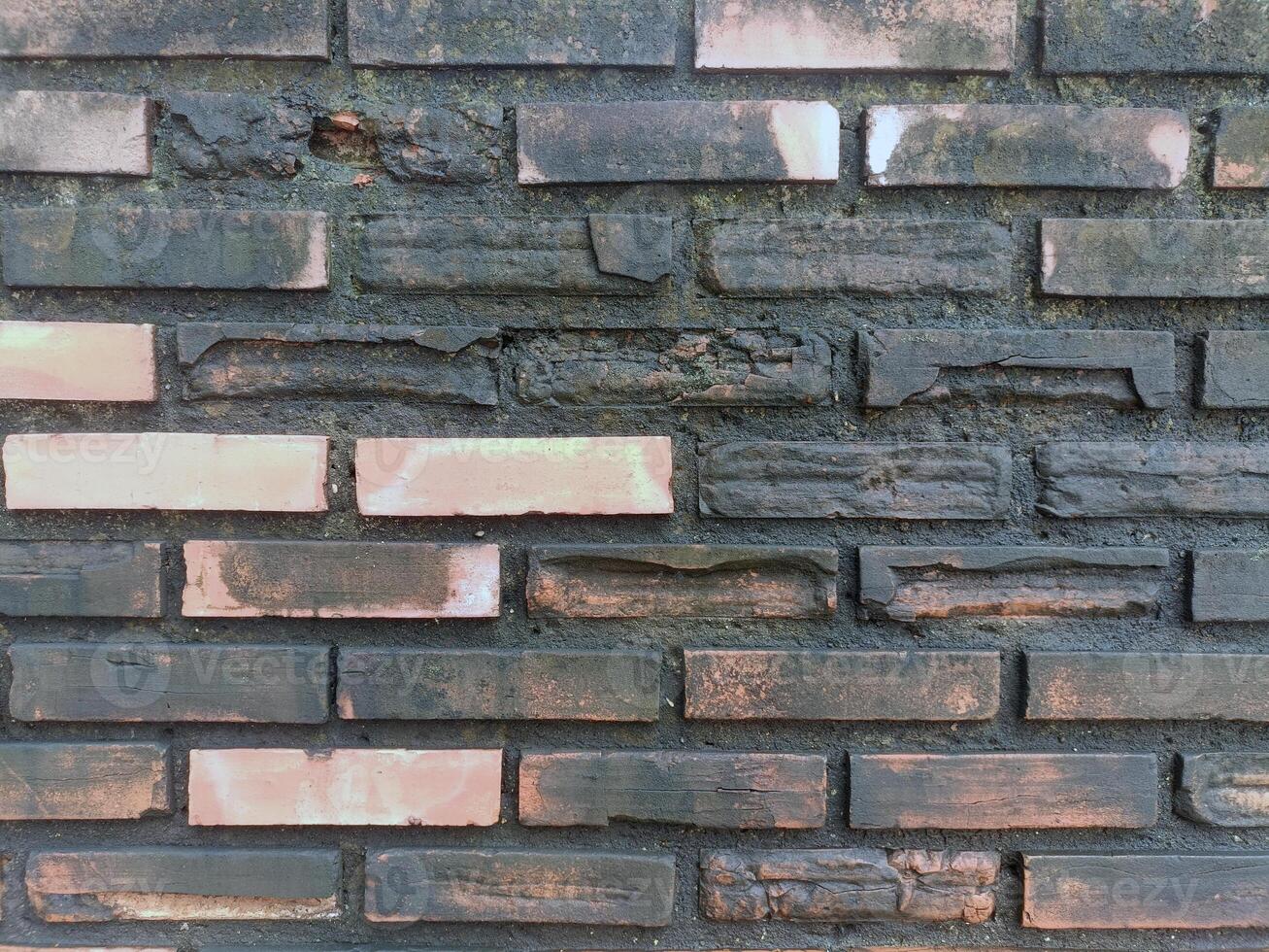 Textured gray wall appears aged and weathered with visible cracks, evoking sense of history and urban decay along street photo