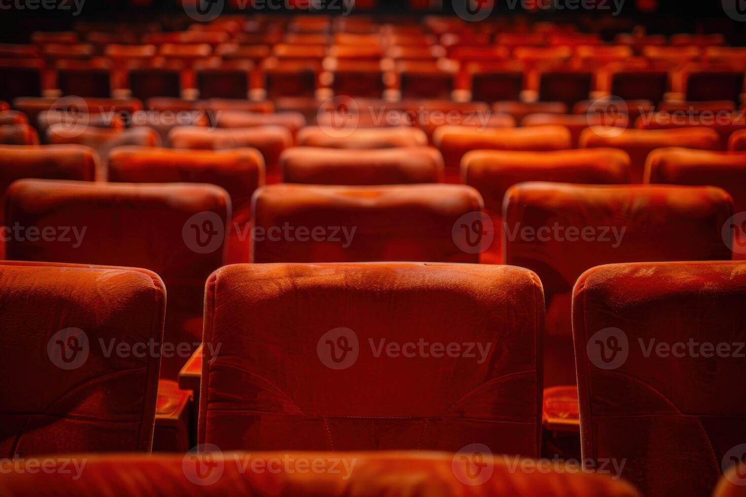Rows of red seats in an auditorium photo