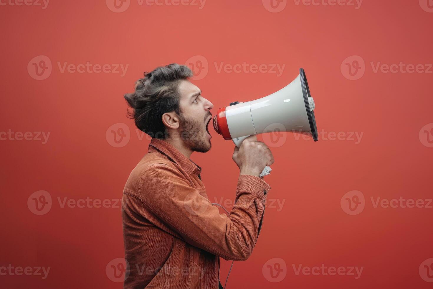A man is shouting into a megaphone photo