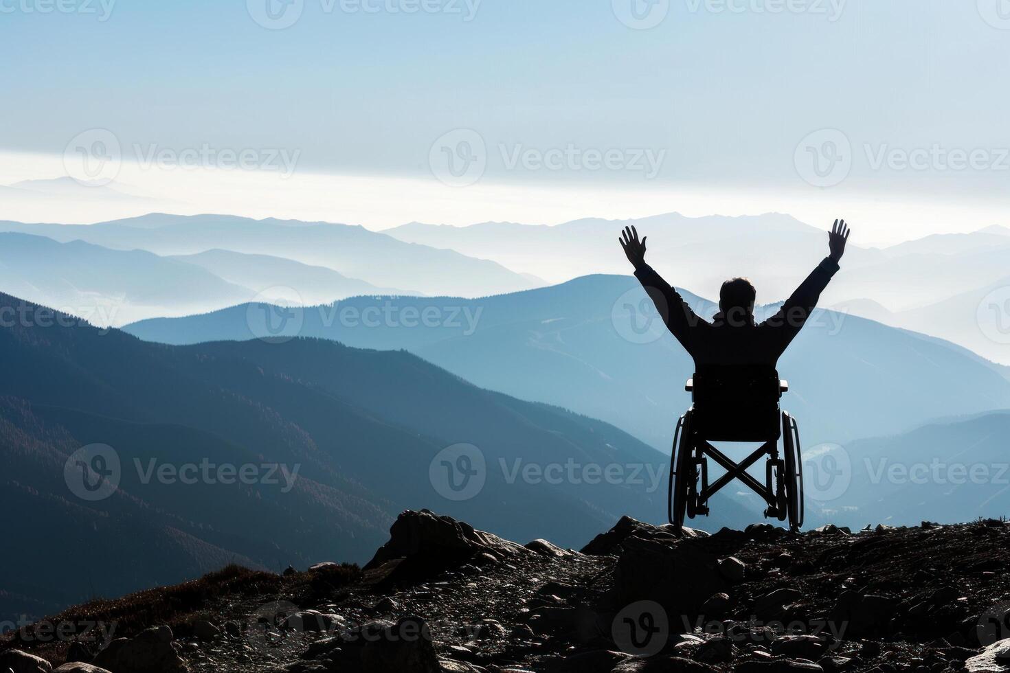 A person in a wheelchair with their arms up in the air photo
