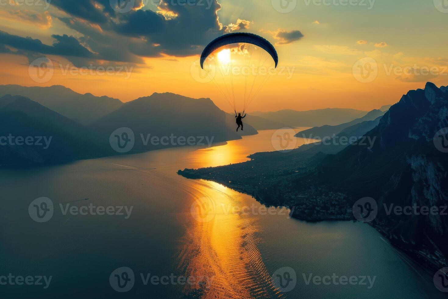 Paraglider flying over lake como at sunset photo