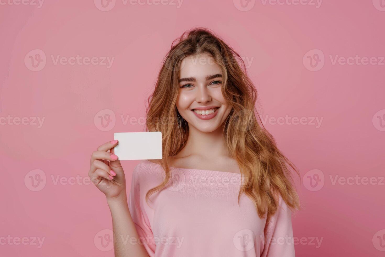 A beautiful young woman holding a blank card photo