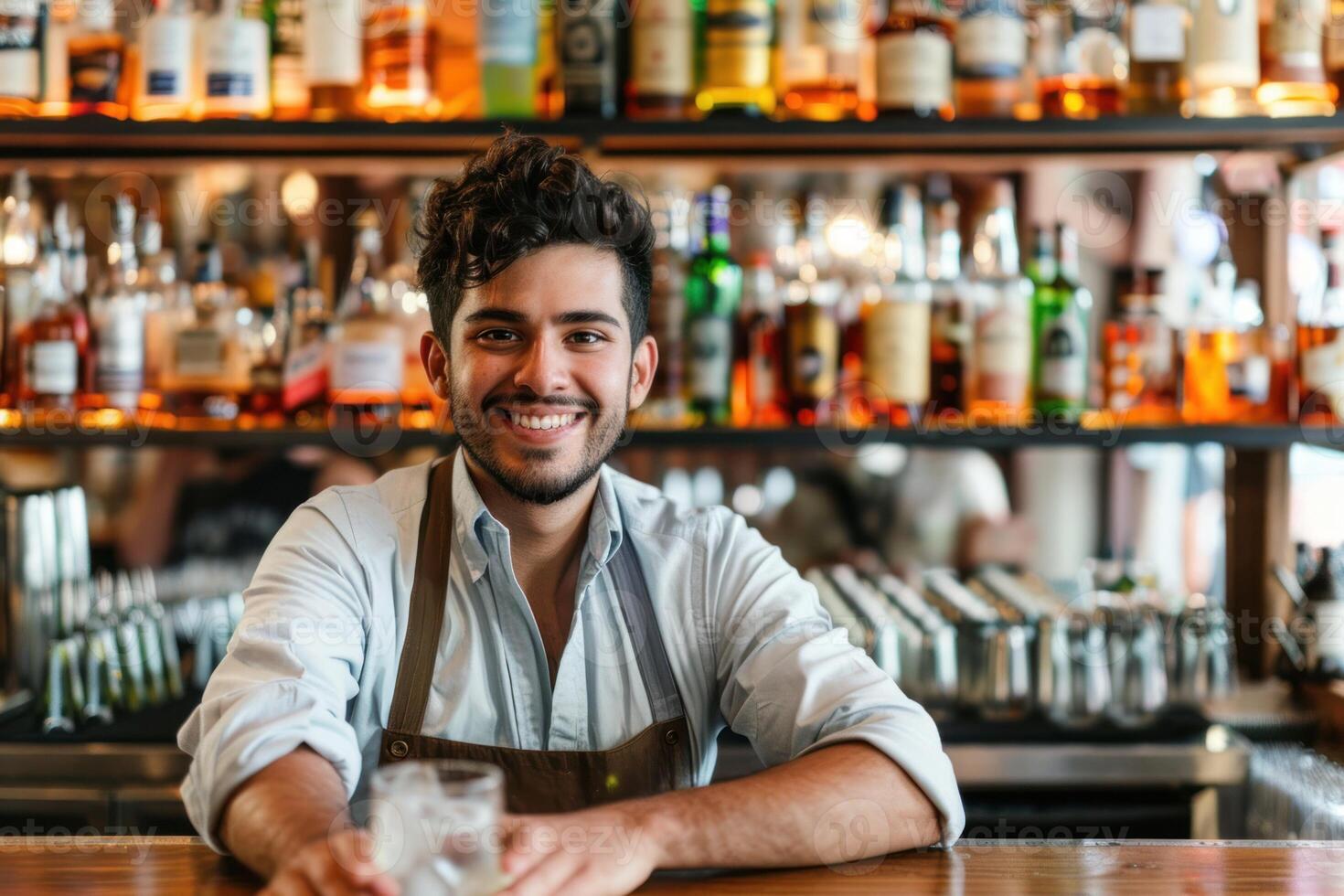 A man sitting at a bar with a drink photo