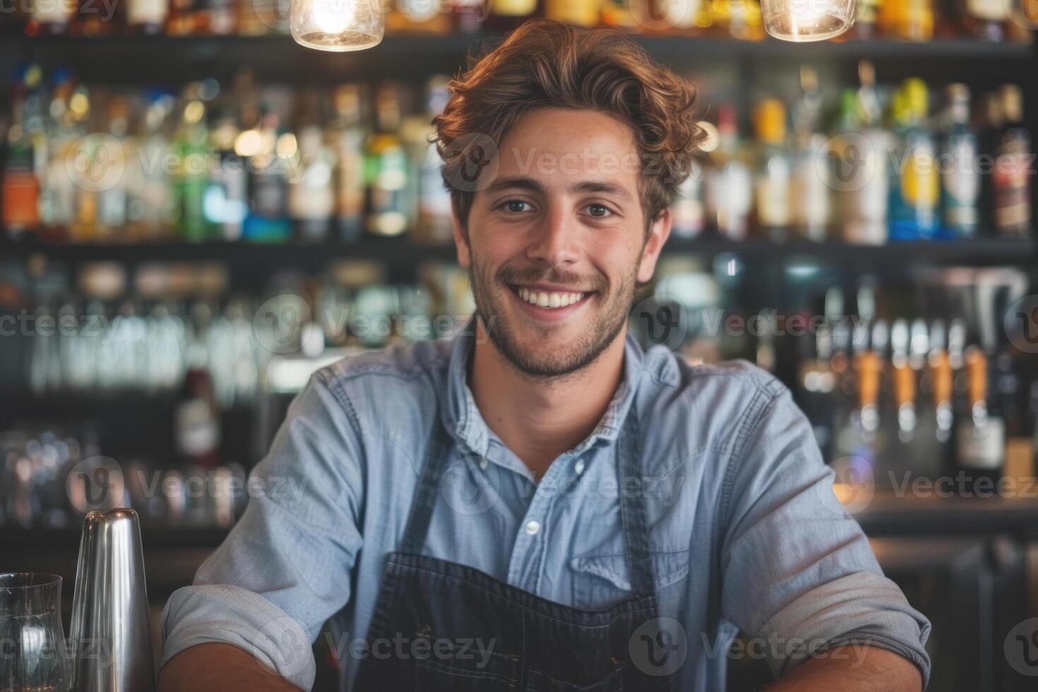 A smiling man in apron at a bar photo